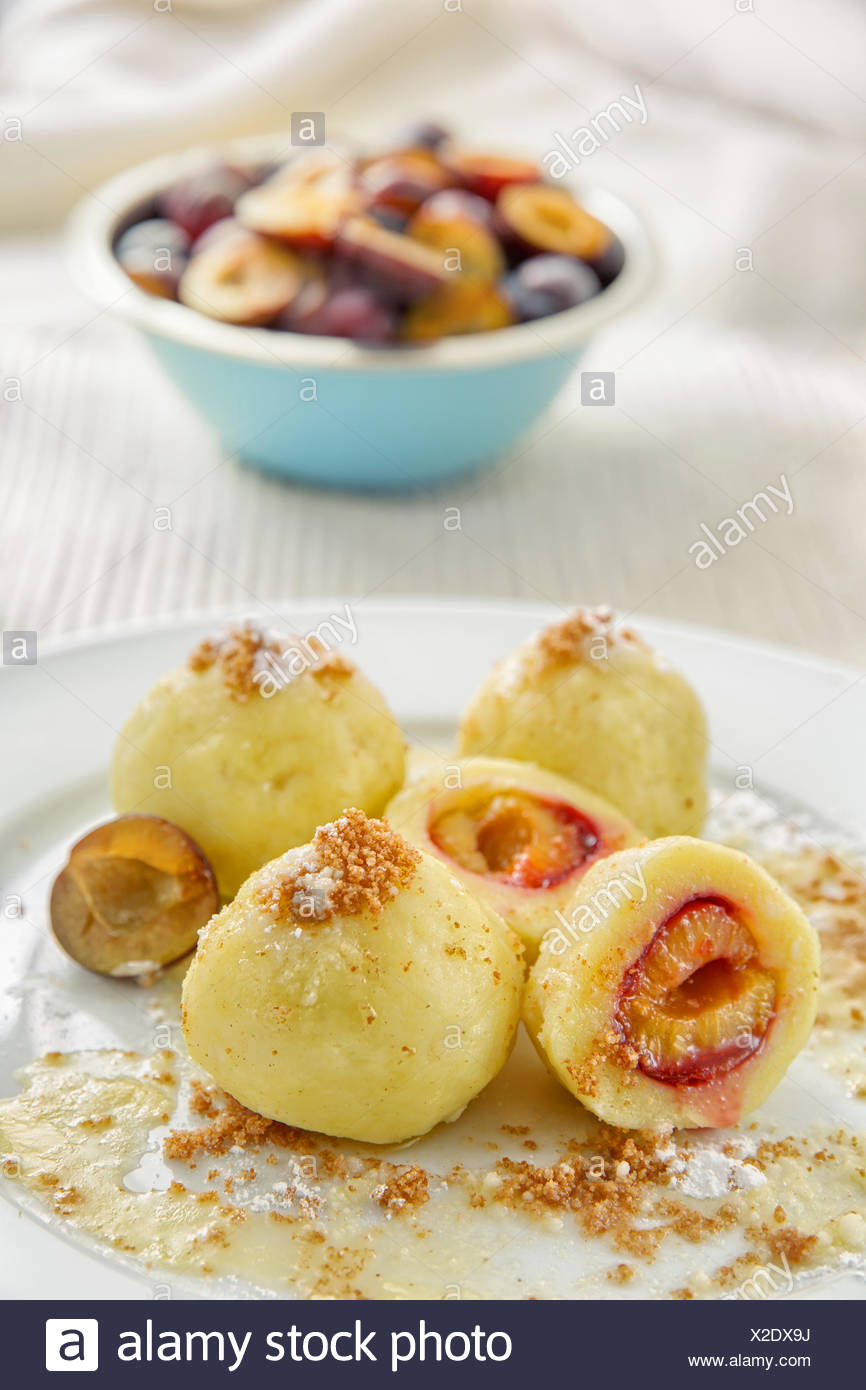 Plum potato dumplings topped with fried bread crumbs with melted butter