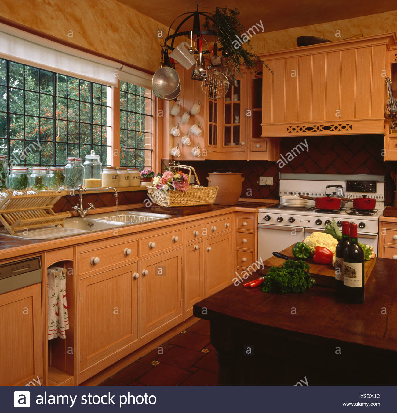 Paint Effect Marbled Walls And Ragged Cupboards In Peach Kitchen With Large Range Oven Stock Photo Alamy