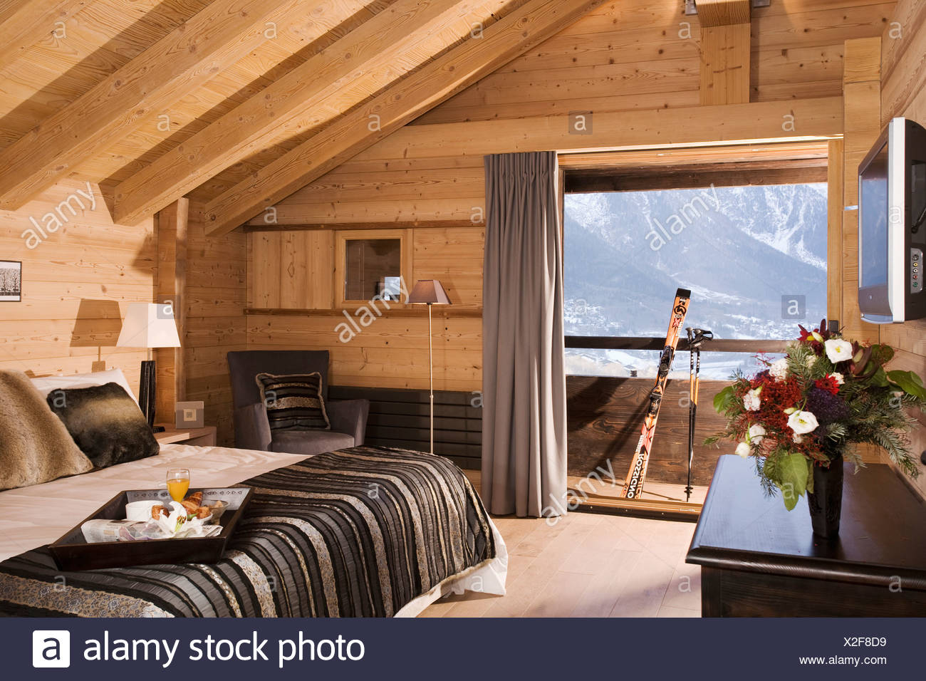 Black Bed Cover On Bed In Modern Bedroom In Alpine Chalet