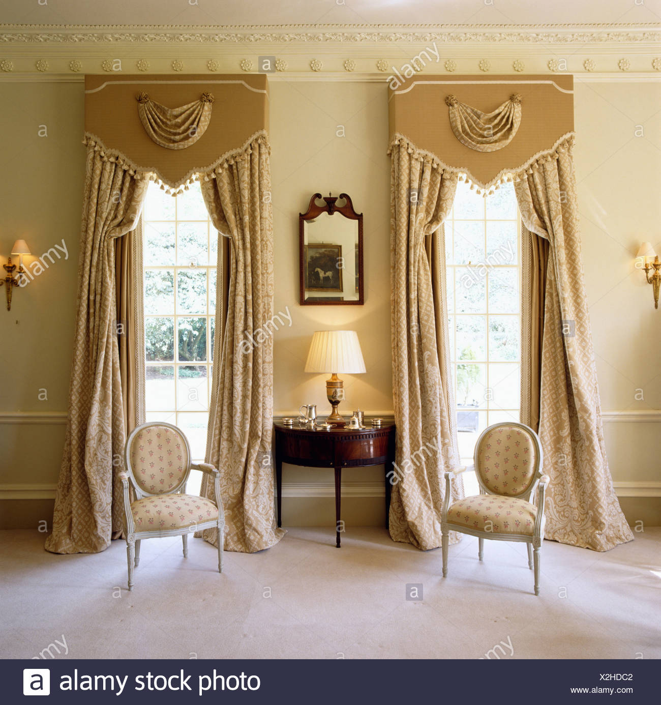 Cream Curtains Below Ornate Pelmets On Windows On Either Side Of