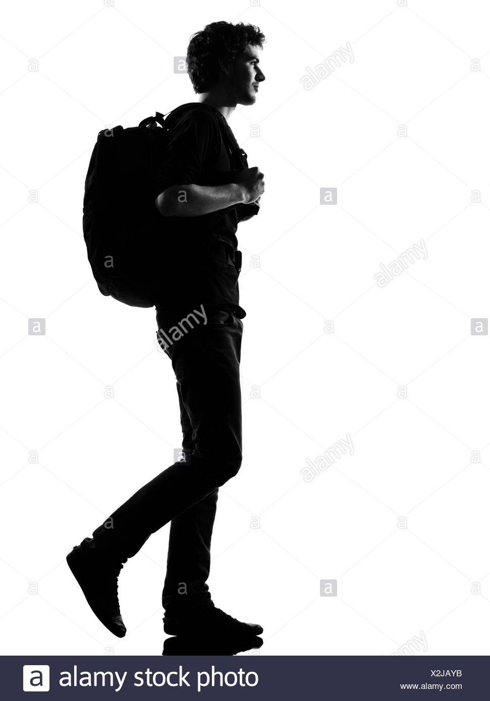 Young Man Backpacker Walking Silhouette In Studio Isolated On