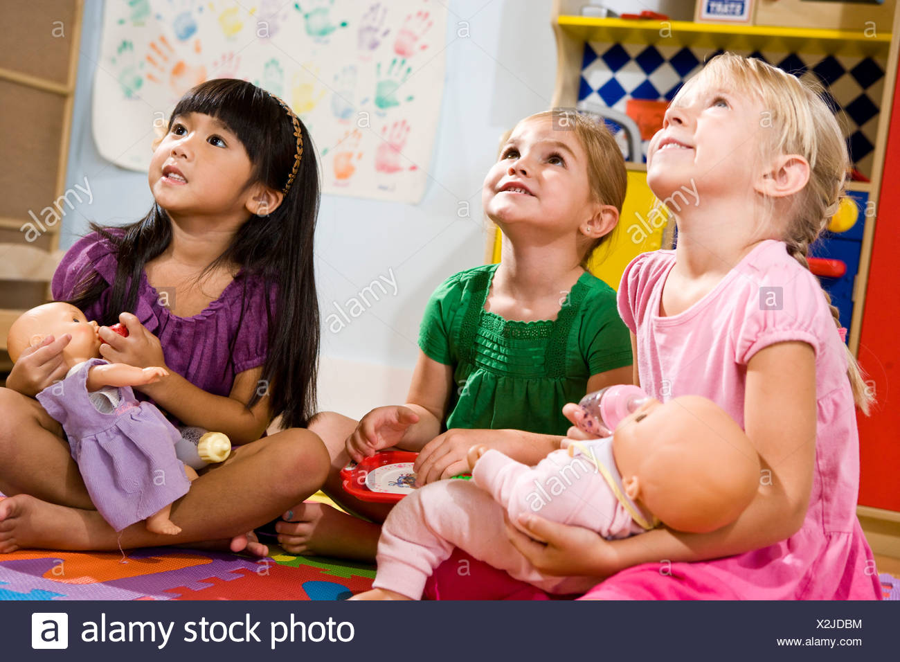 little girls playing with baby dolls