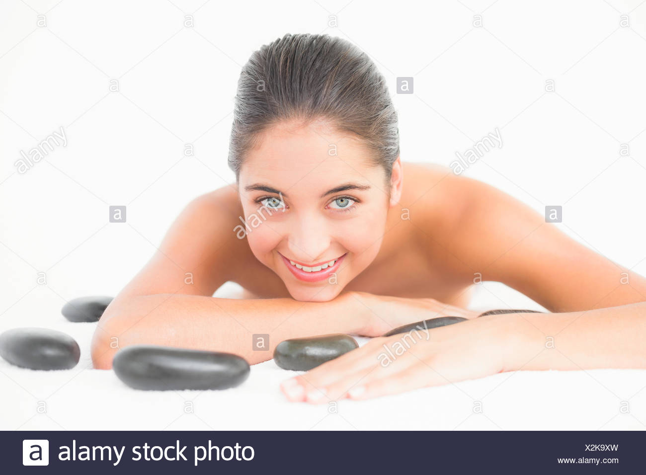 Pretty woman enjoying lying nearby hot stones Stock Photo