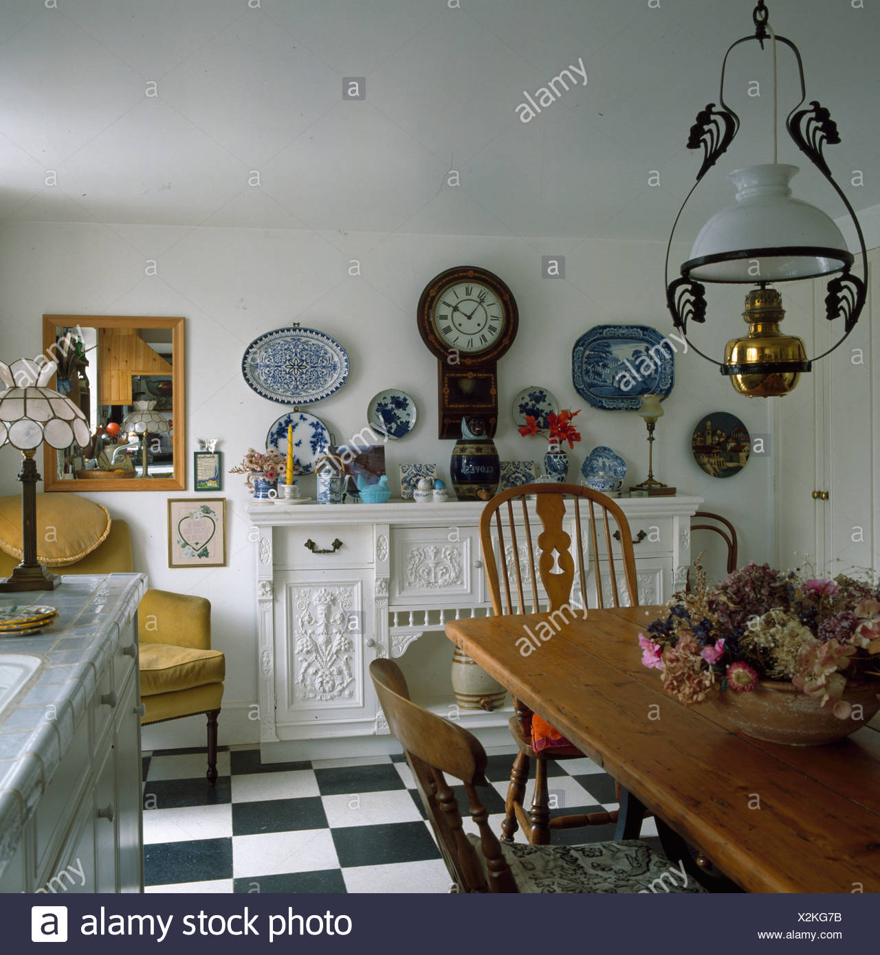 Victorian Style Lantern Above Wooden Table And Chairs In Country Kitchen With Black White Flooring Stock Photo Alamy