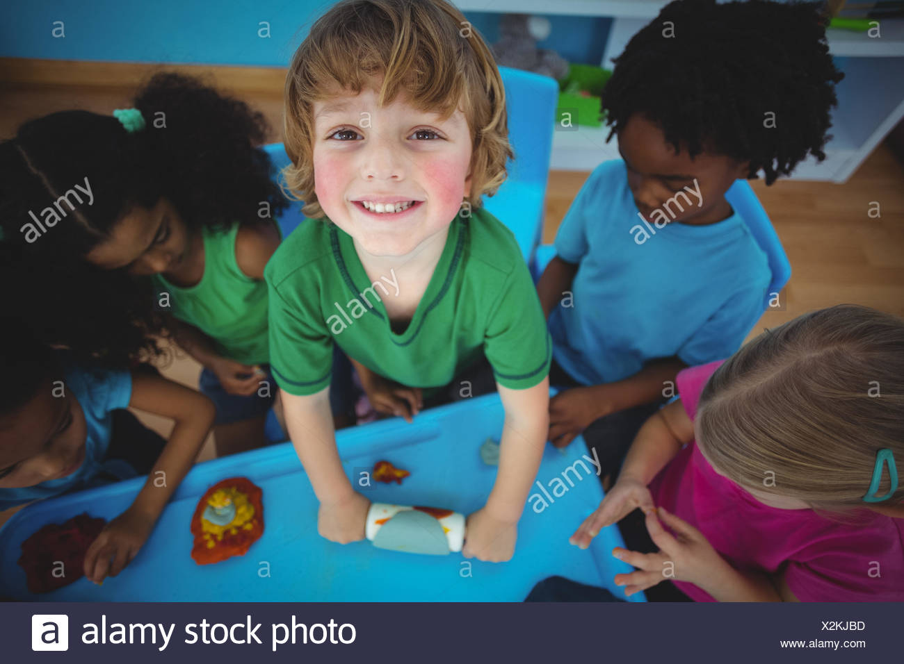 Smiling Kids Playing With Modelling Clay Stock Photo
