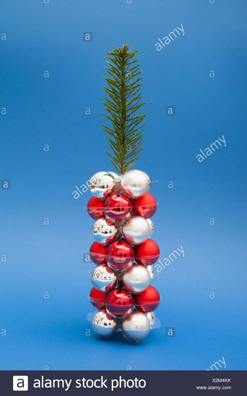 Christmas Tree Made Of Twig And Ornaments Against Blue Background