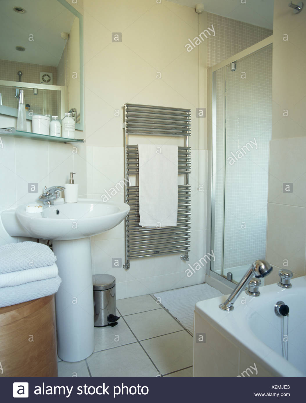 Wall Mounted Chrome Radiator Beside Glass Shower Cabinet And White