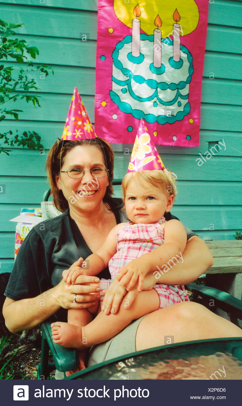 Baby S First Birthday Party Baby Aunt Wearing Party Hats Uk Stock