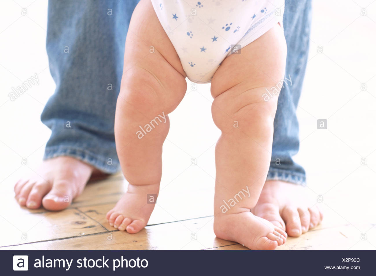 Baby's legs. Legs of a 6-month-old baby boy who is being supported ...