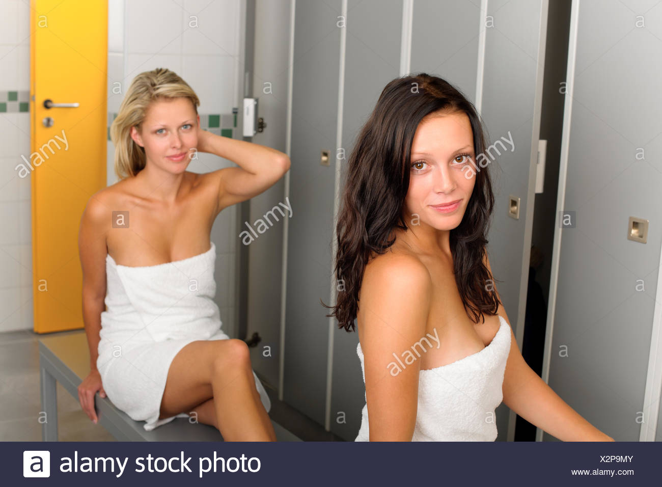 Locker Room Two Relaxed Women Wrapped In Towel Stock Photo