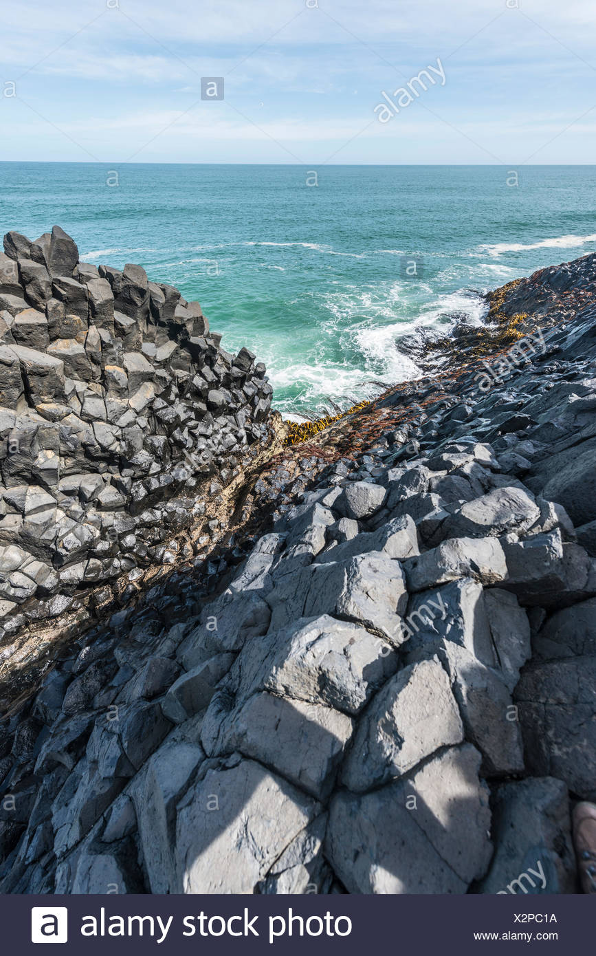 Hexagonal basalt column by the sea, Blackhead, Dunedin, Otago, South Island, New Zealand Stock Photo
