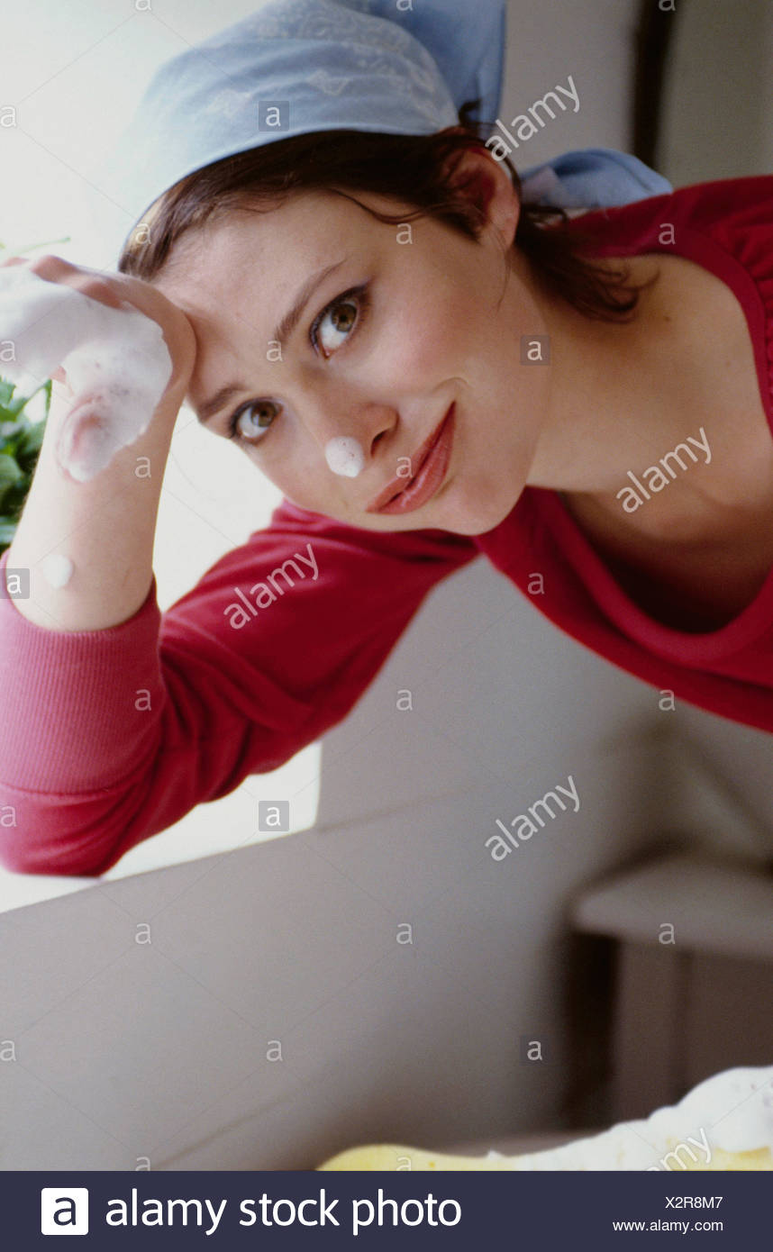 Female Short Brunette Hair Wearing Red Top And Light Blue And