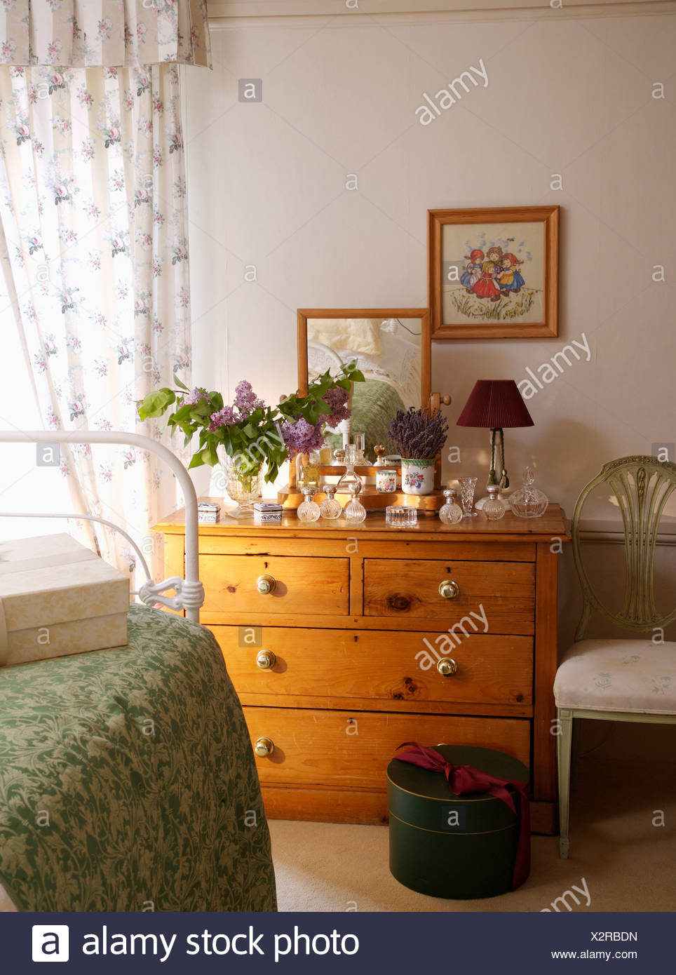 Pictures Above Pine Chest Of Drawers In Country Bedroom With