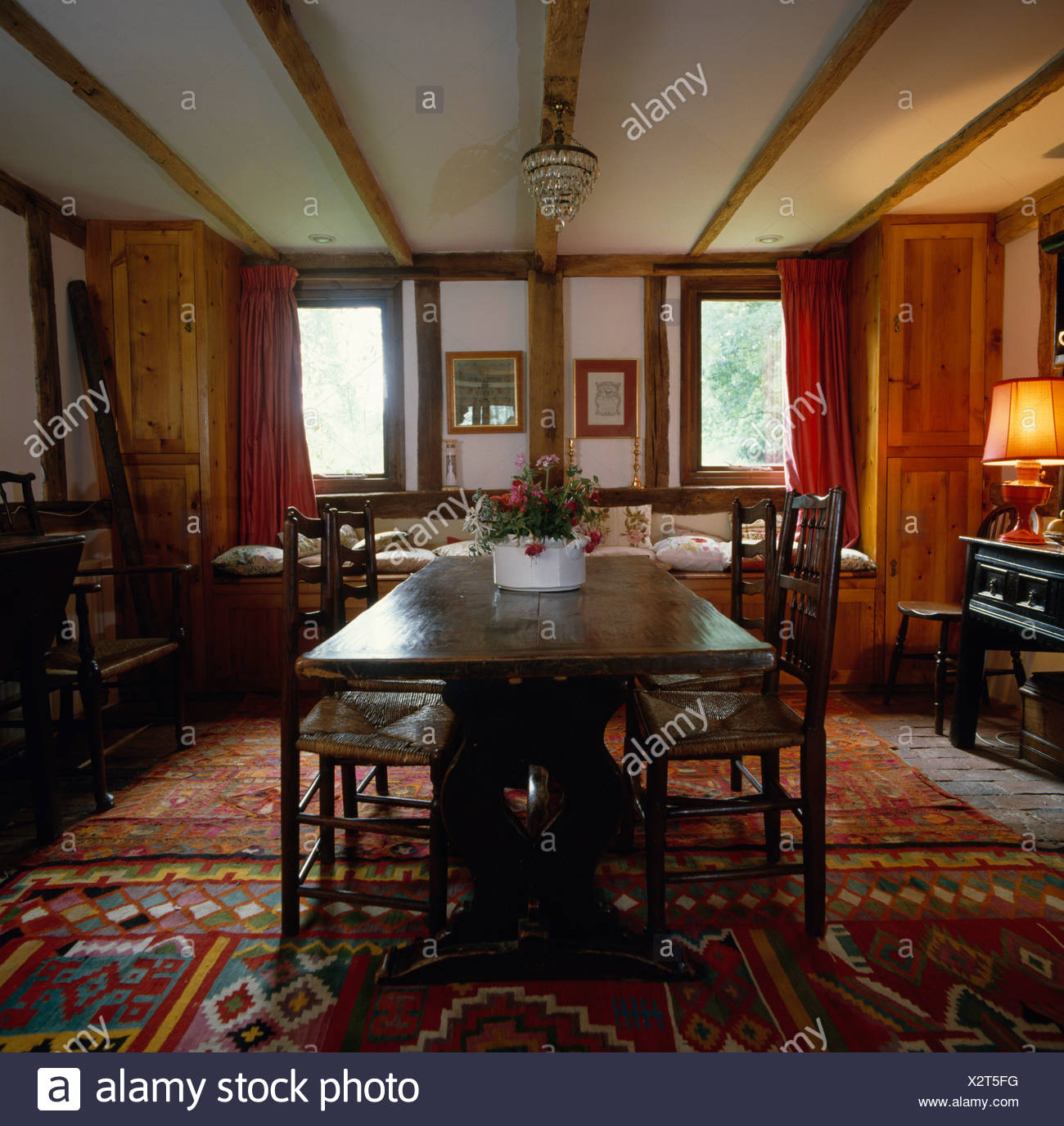 Antique Oak Table And Chairs In Country Dining Room With Kelim Rugs On The Floor Stock Photo Alamy