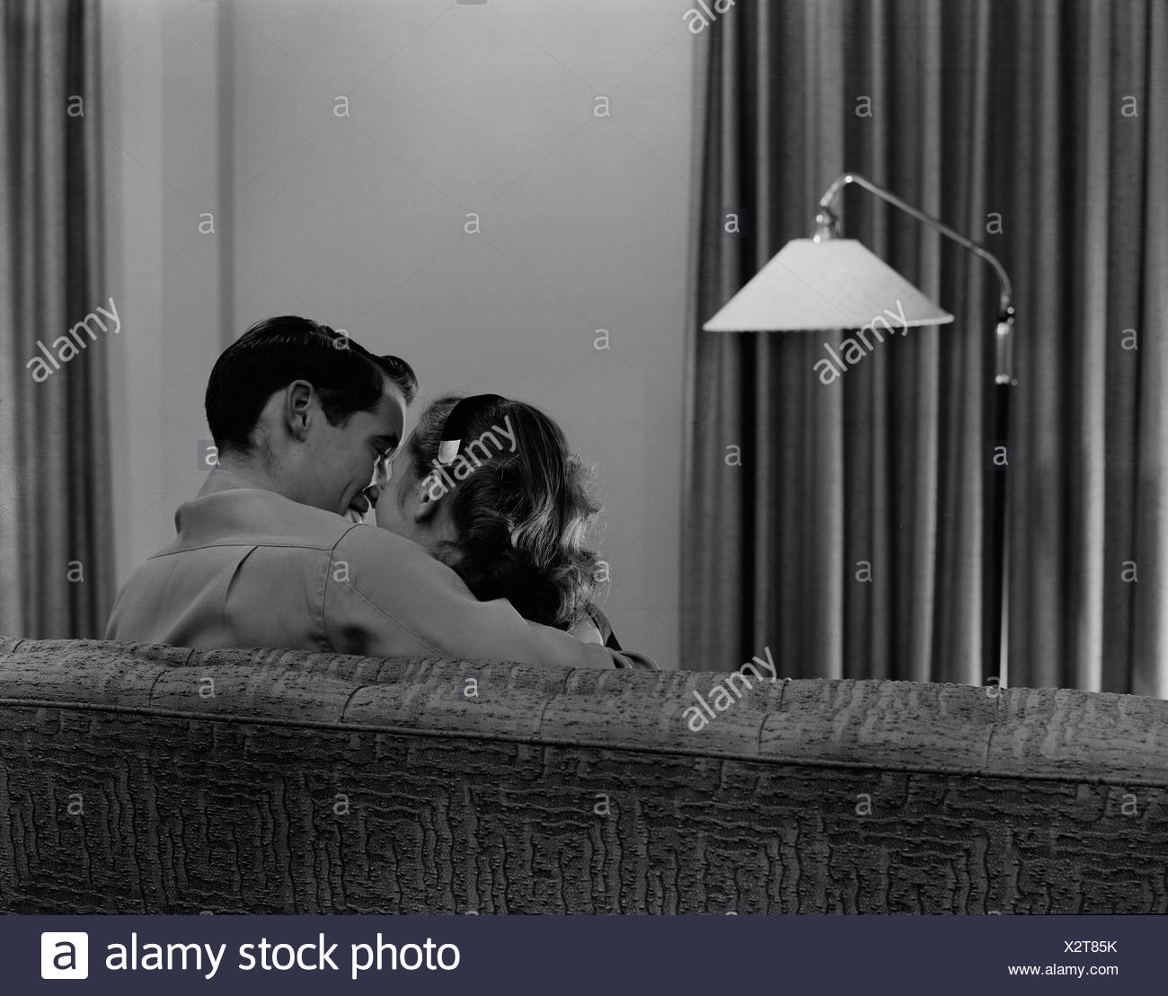 Young Couple Kissing On Sofa Rear View Stock Photo 277128479 Alamy