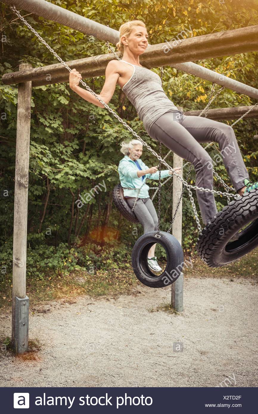 Two Women On Swings Stock Photos Two Women On Swings Stock