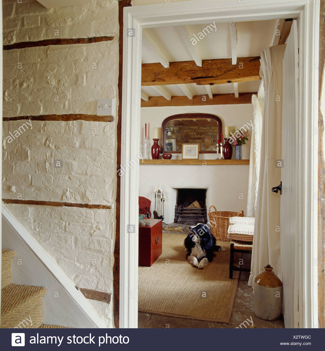 White Painted Brick Wall In Cottage Hall With Door Open To