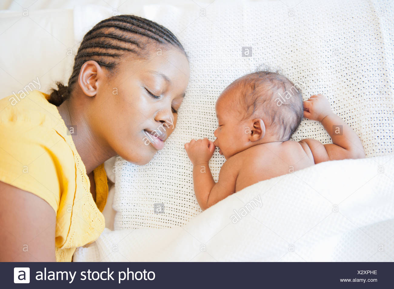 Mother Sleeps On Bed Facing Her Sleeping Newborn Baby In Johannesburg South Africa Stock Photo Alamy