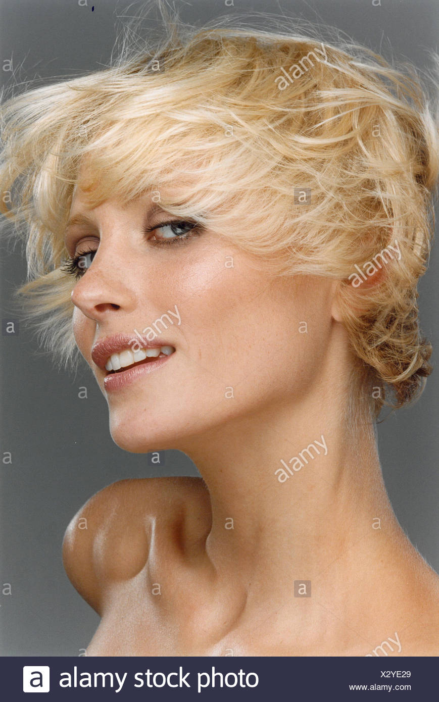 Female With Short Blonde Hair Swept Forwards Over Face Natural
