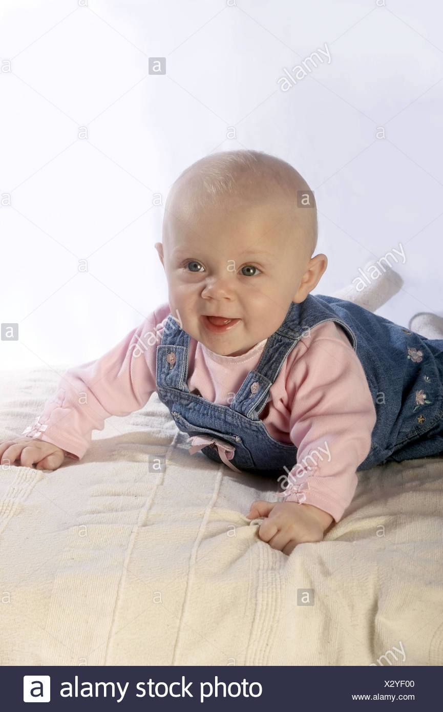4 Month Old Baby Girl Smiling Off Camera Lying On Her Tummy Stock Photo Alamy