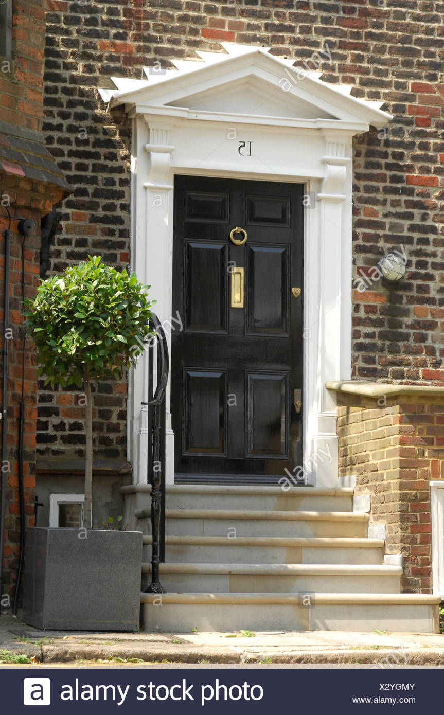 A Traditional Black Front Dowith White Pediment Stone Steps
