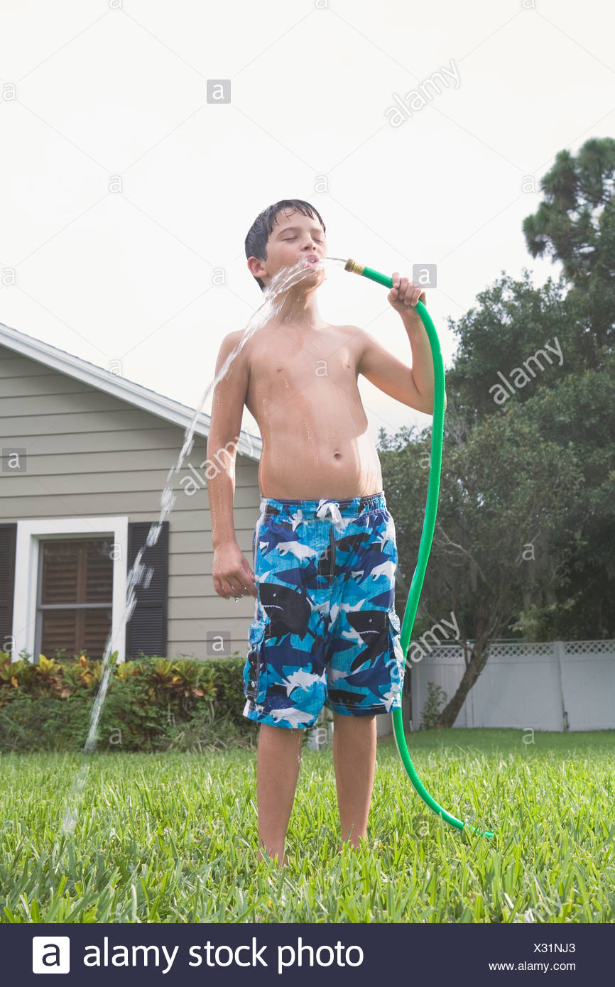 Child Water Hose Drink Stock Photos & Child Water Hose Drink Stock