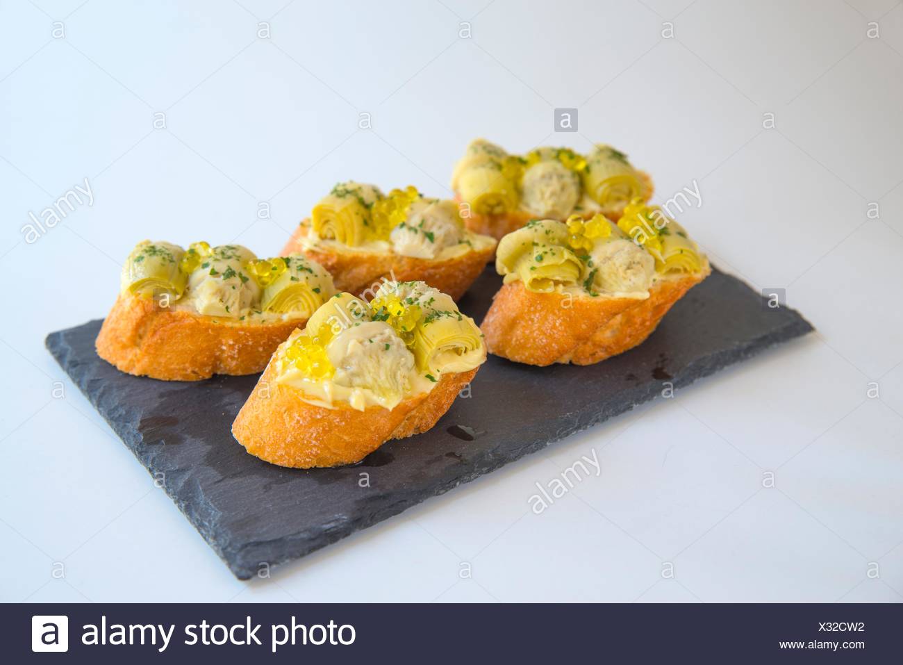 Spanish Tapas Artichokes With Alioli Sauce And Pearls Of Olive Oil And Parsley Stock Photo Alamy