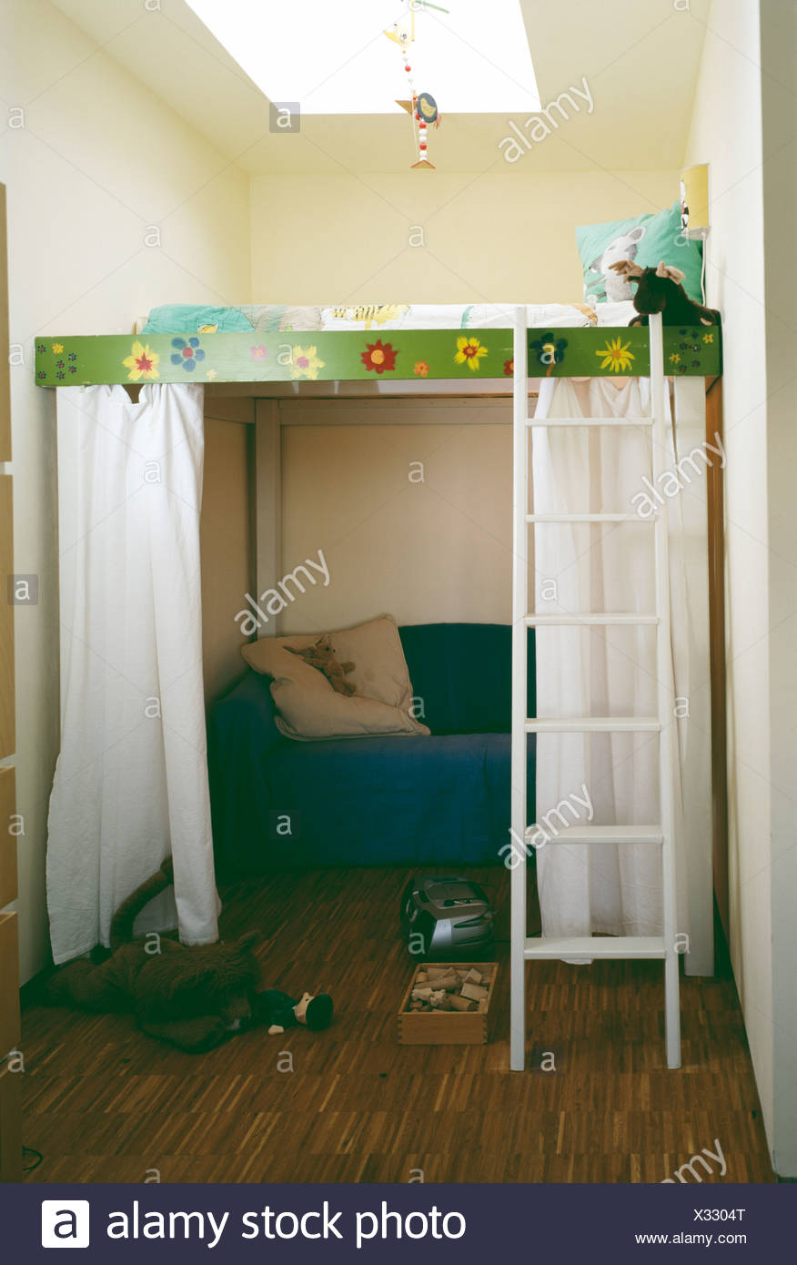 Bedroom With Raised Cabin Bed With White Ladder Over Blue Armchair