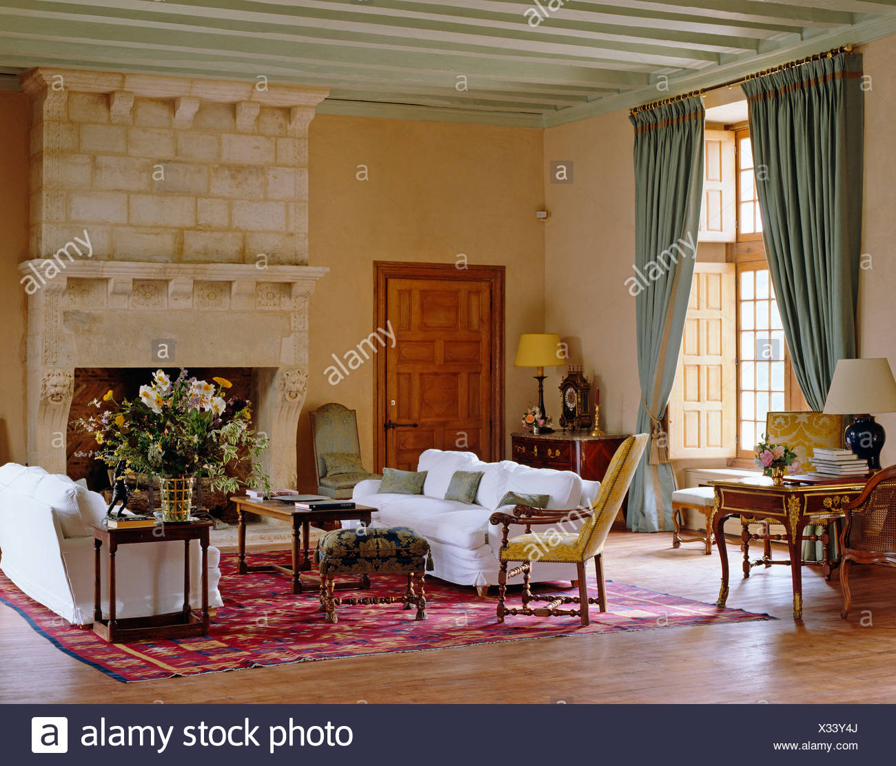 Comfortable White Sofas On Either Side Of Tall Stone Fireplace In