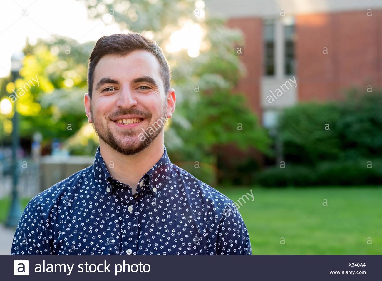 Male College Senior Outdoors For A Natural Light Portrait On A University Campus In Oregon Stock Photo Alamy