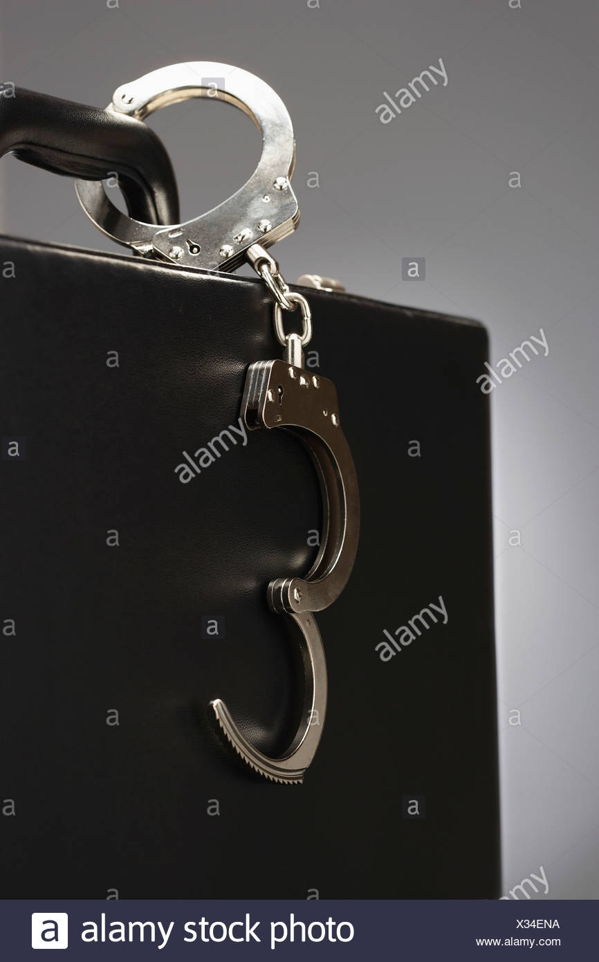Handcuffs Attached To Briefcase High Resolution Stock Photography and