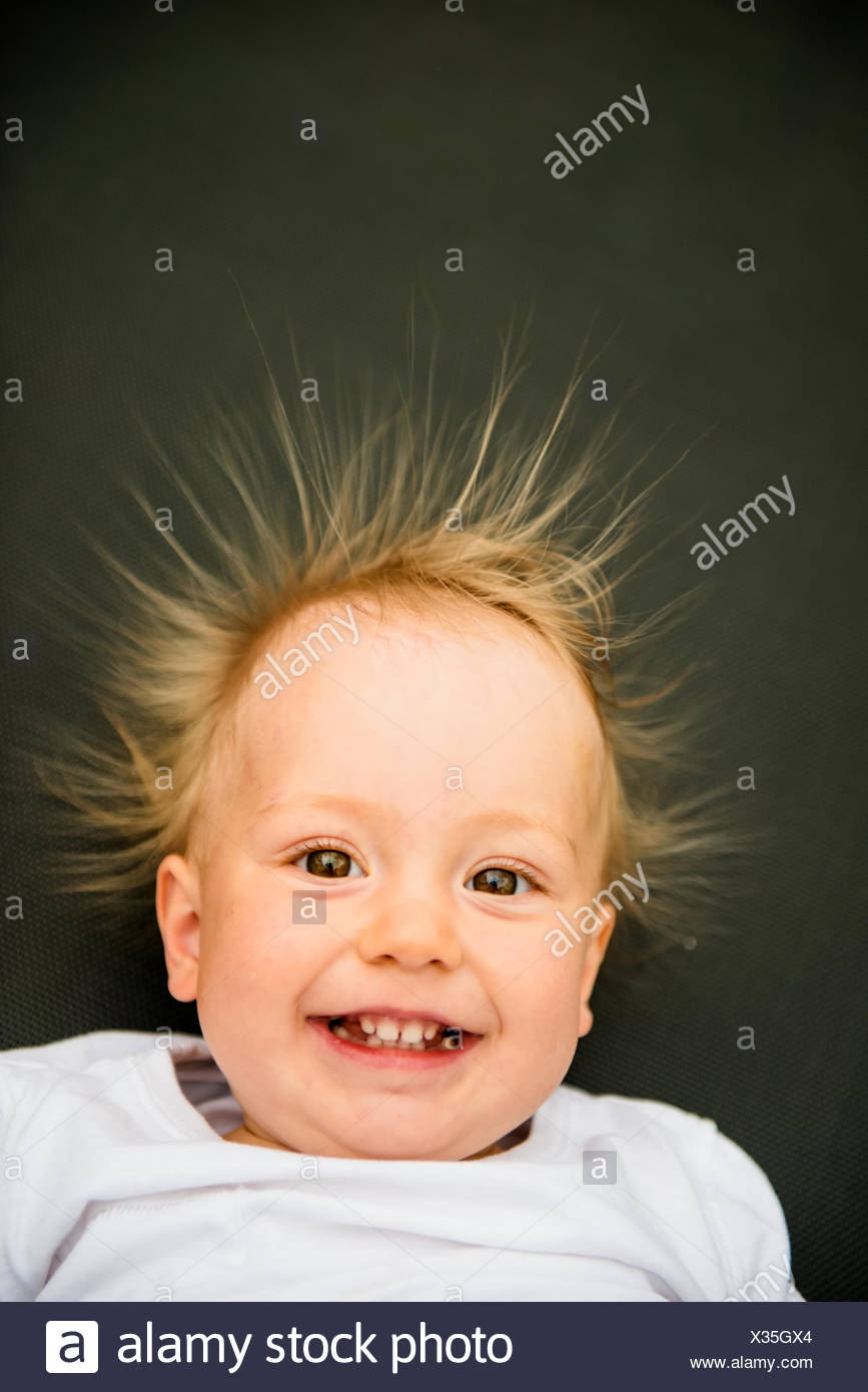Portrait Of Smiling Baby With Standing Hair From Static
