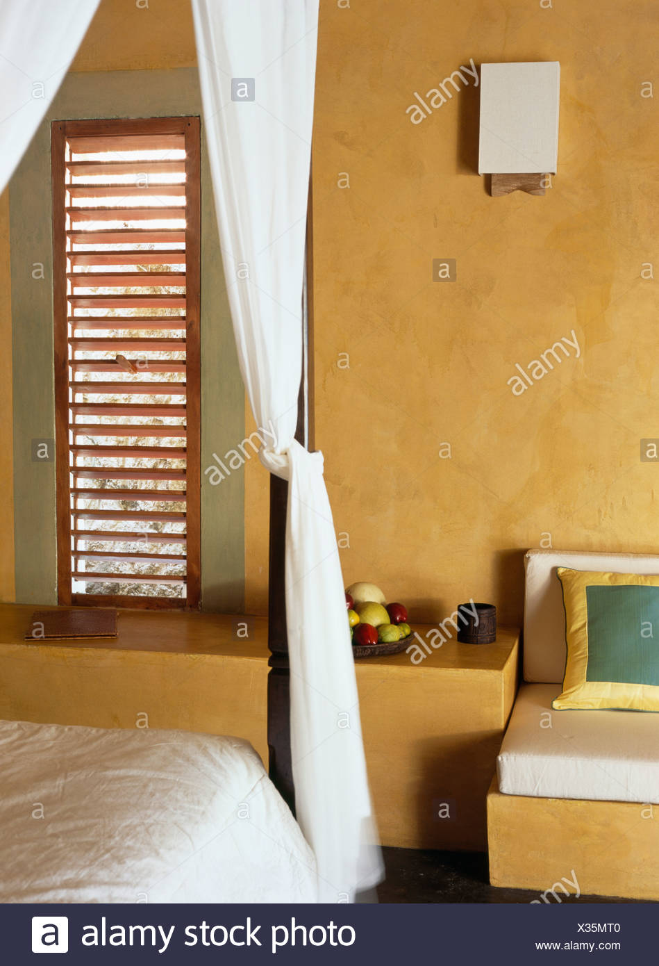 Close Up Of White Drapes In Bedroom With Rough Yellow Walls And