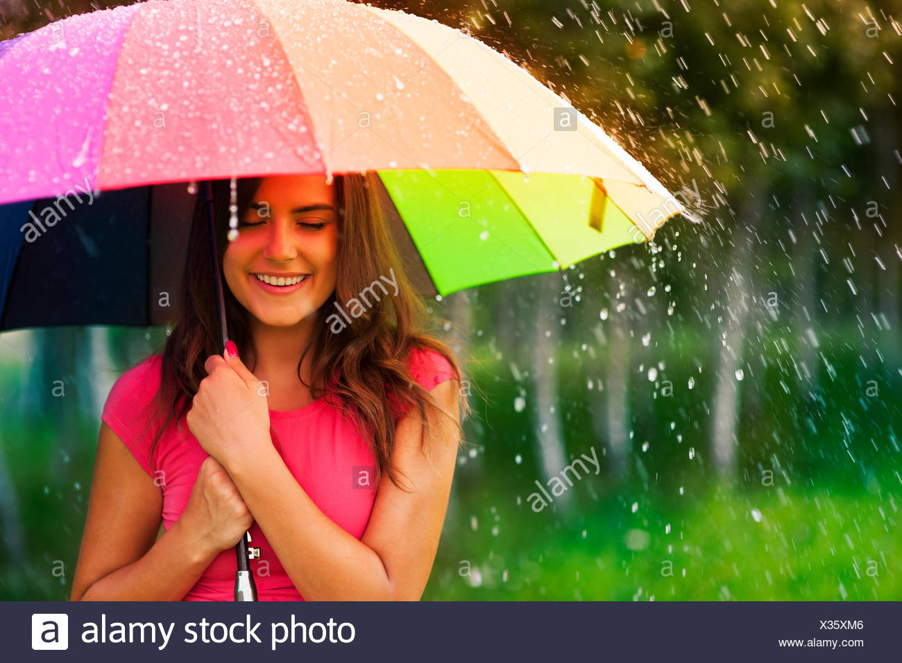 Beautiful Woman Under Rainbow Umbrella Stock Photo