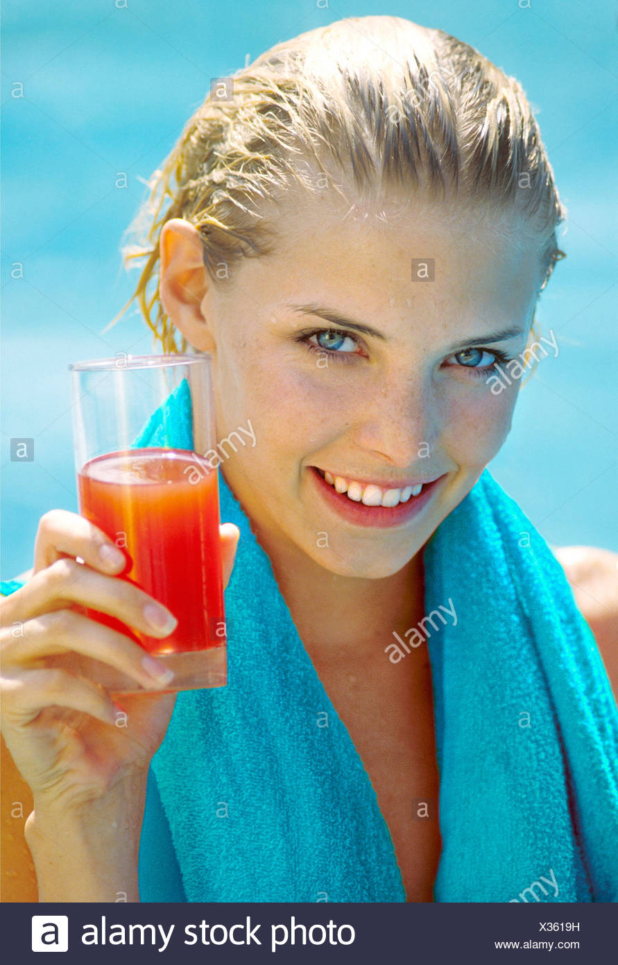 Blonde Female Wet Hair Slicked Back A Blue Towel Round Her