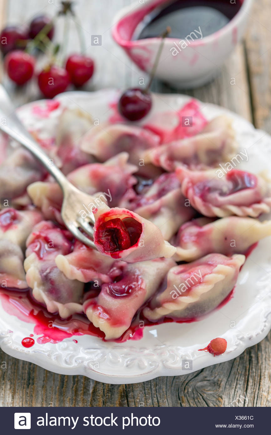 Plate With Cherry Dumplings And Red Sauce Stock Photo Alamy