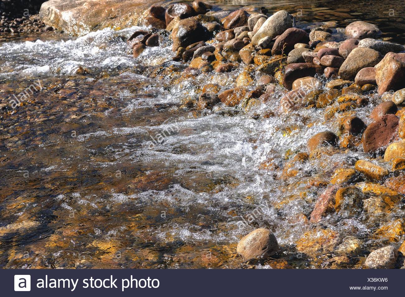 dammed water dam with stones Stock Photo