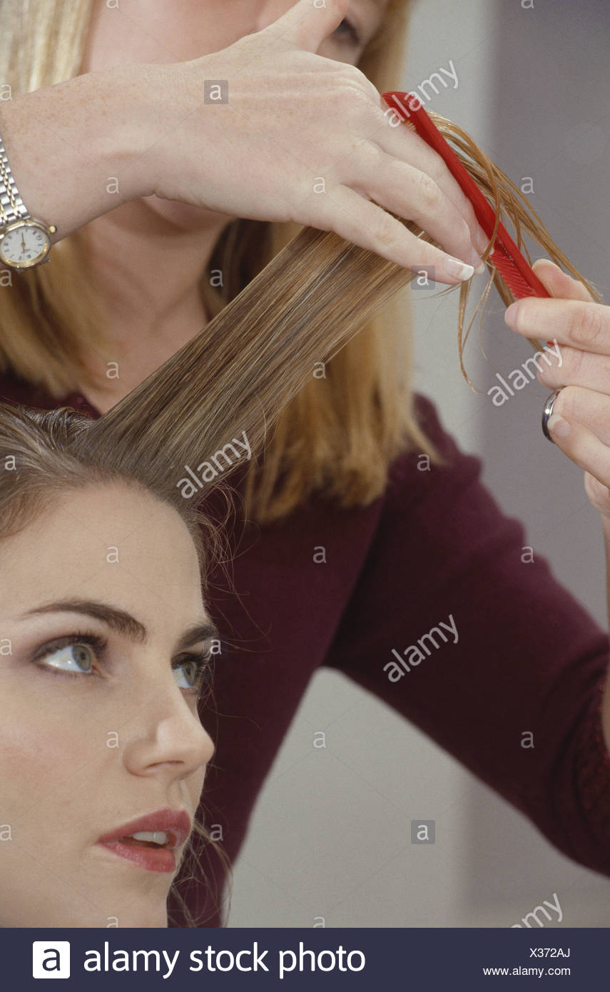 Female With Wet Brunette Hair Having Fringe Combed With Red Comb