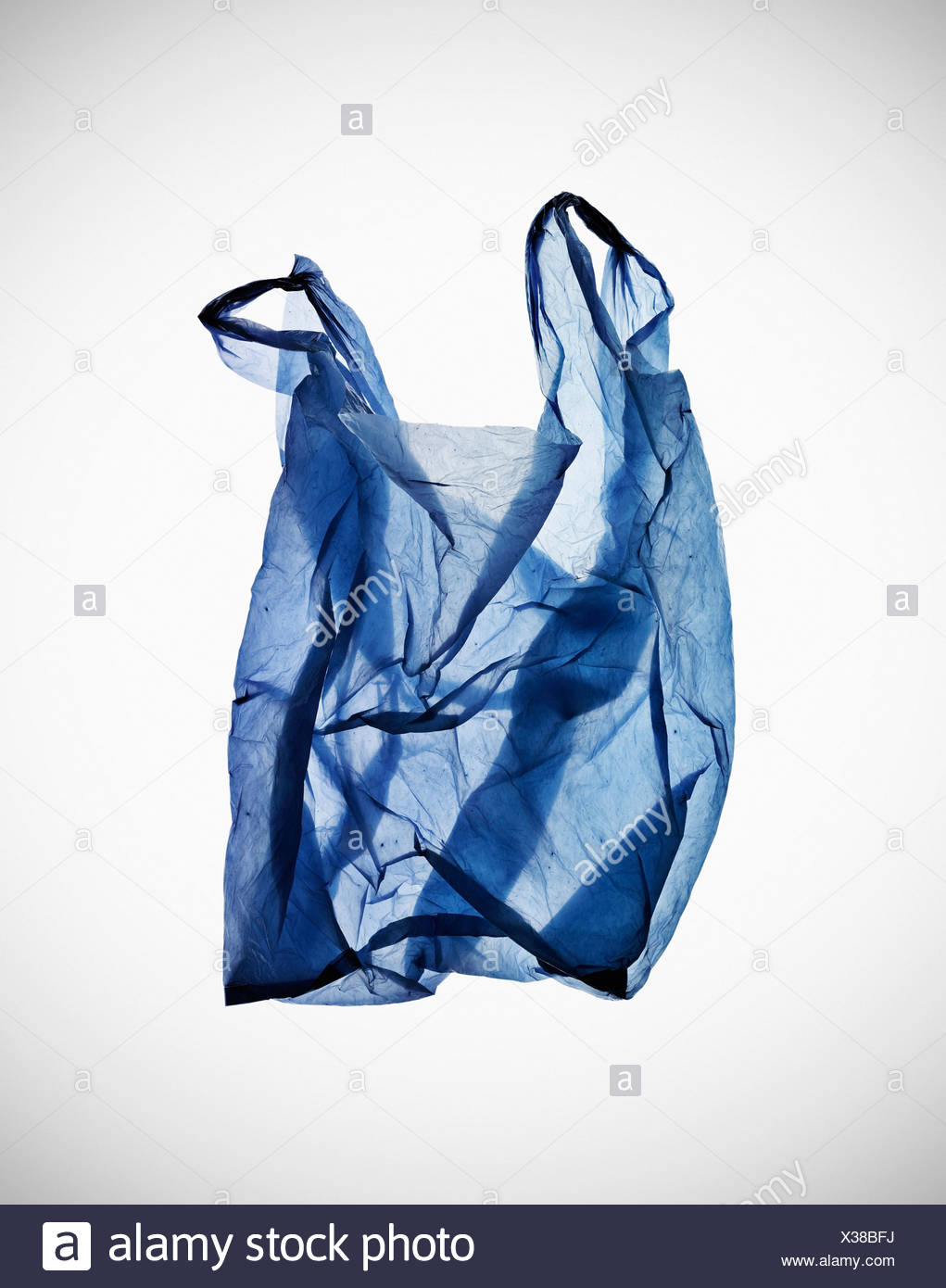 Crumpled blue plastic bag on table Stock Photo