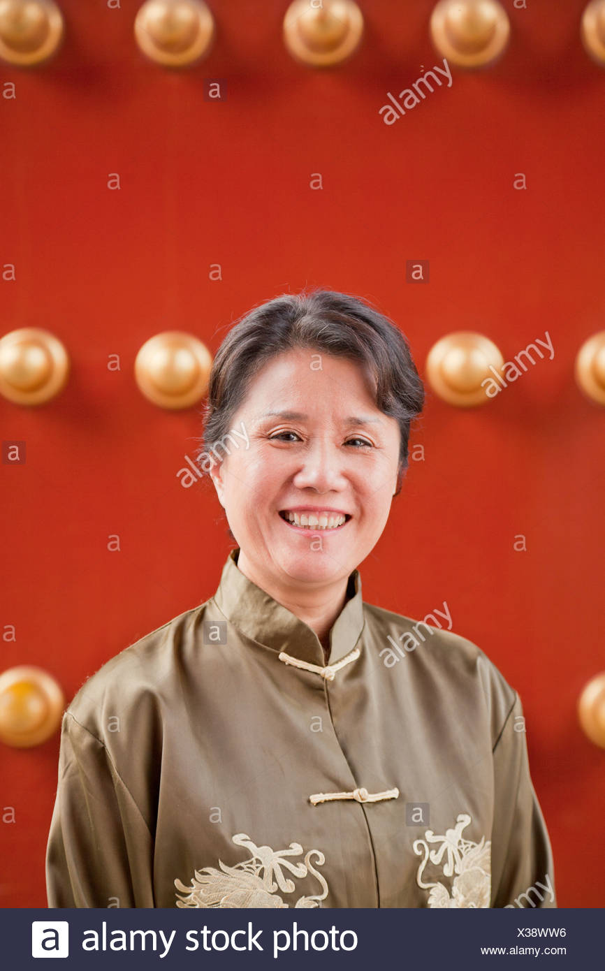 Mature Woman In Traditional Clothes Standing Next To