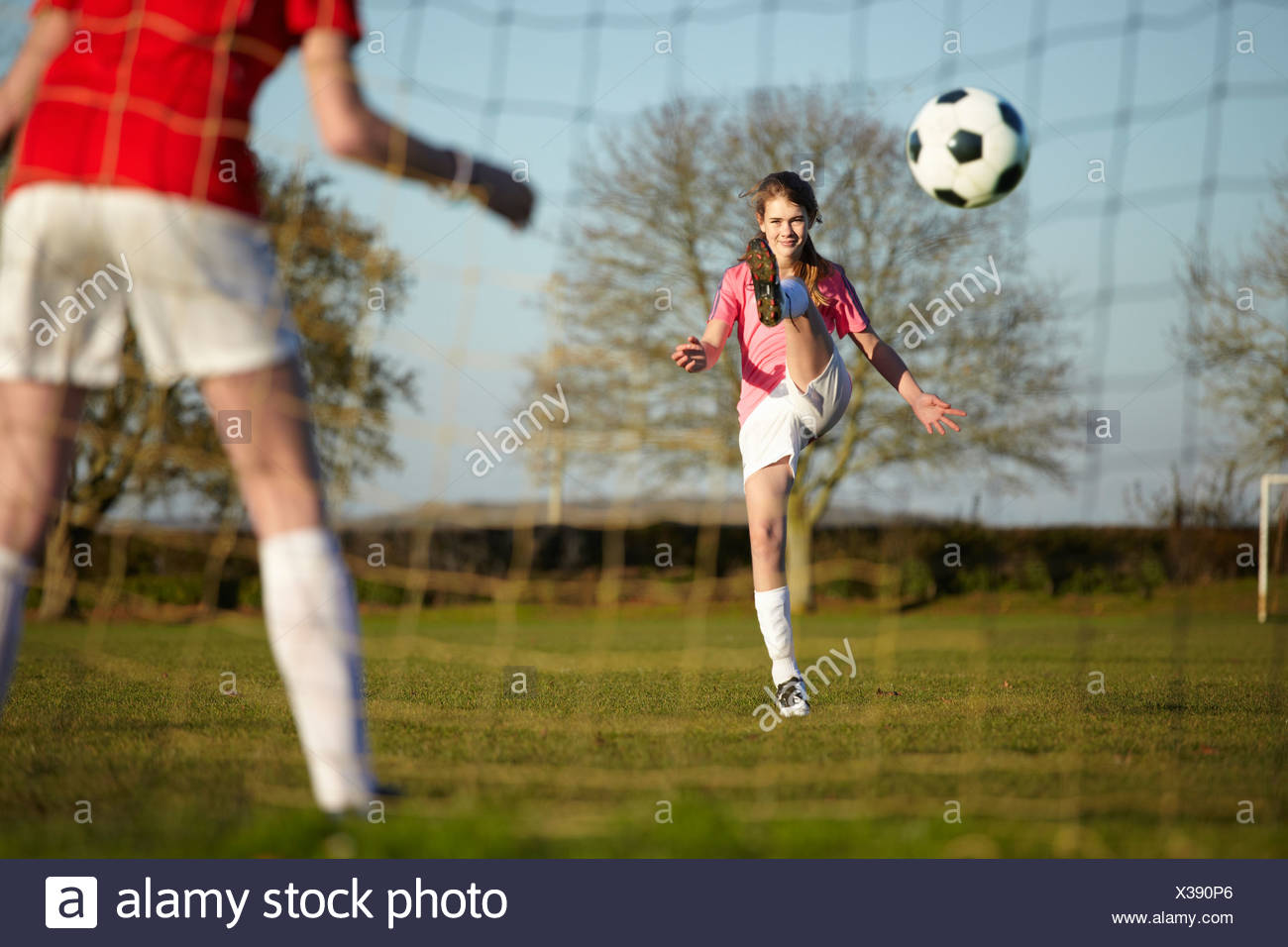 Girl Kicking Football Ball Into Goal Stock Photo Alamy