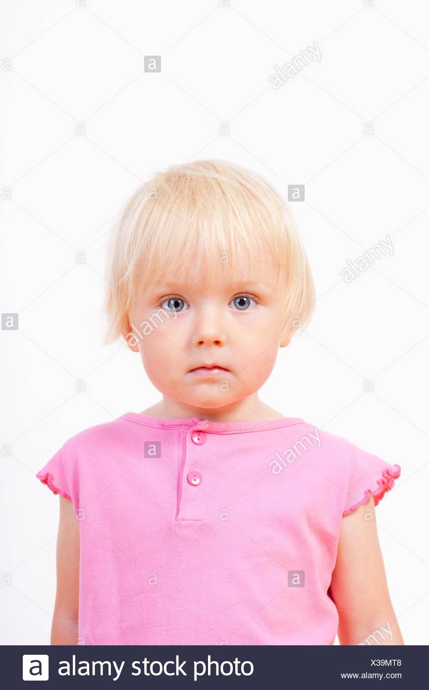 Portrait Of A Little Girl With Blond Hair And Blue Eyes Isolated
