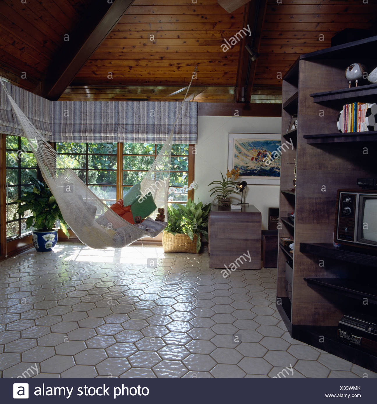 White Tiled Floor And Hammock Suspended From Wooden Ceiling In