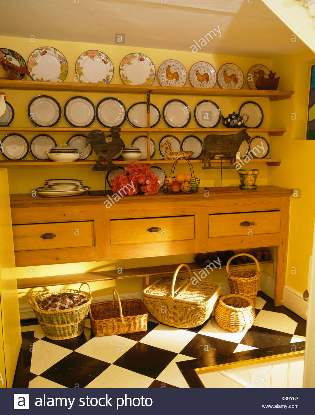 Plates On Shelves Above Dresser In Yellow Country Hall With