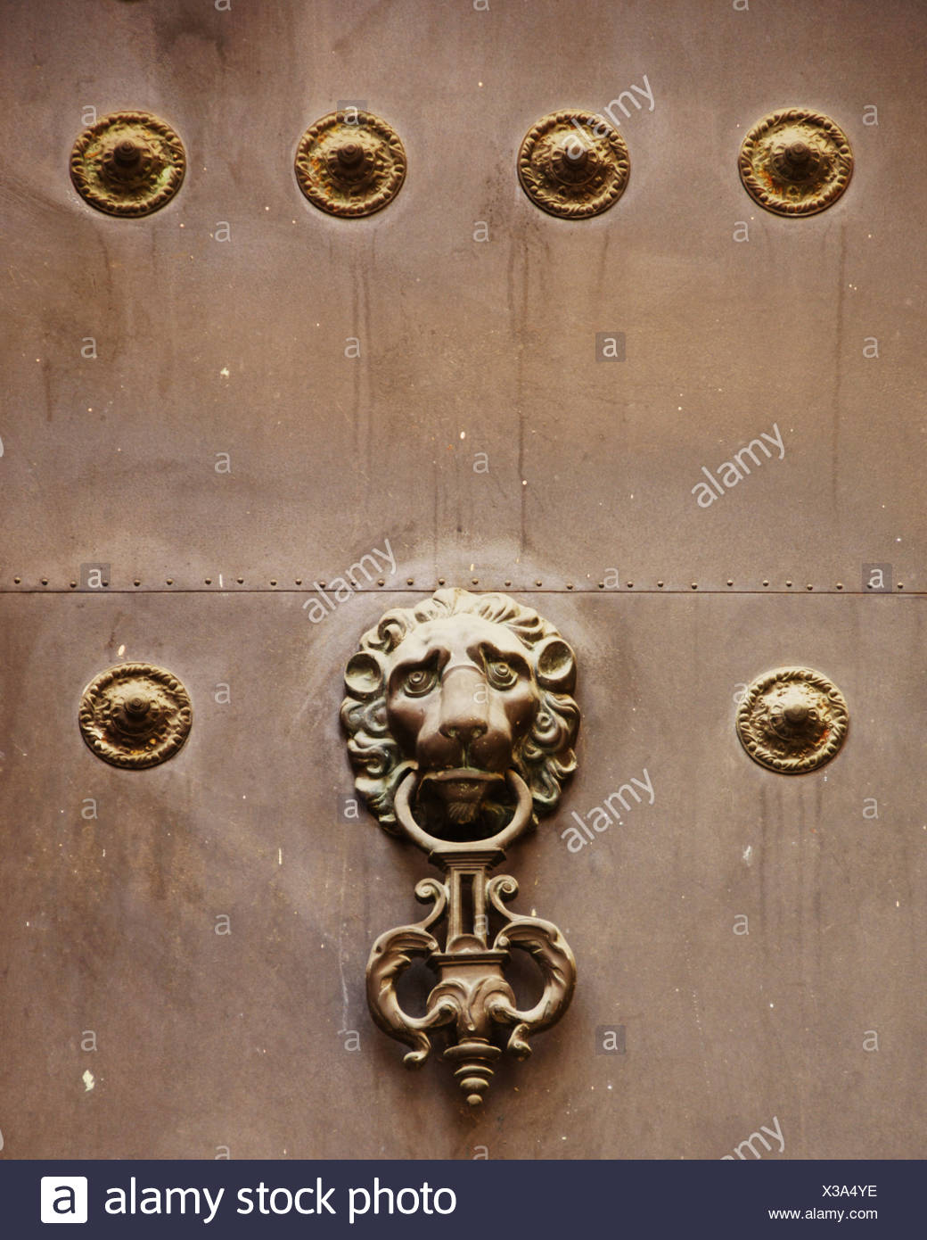 Lion head door knocker on an old door in Seville, Andalusia, Spain Stock Photo