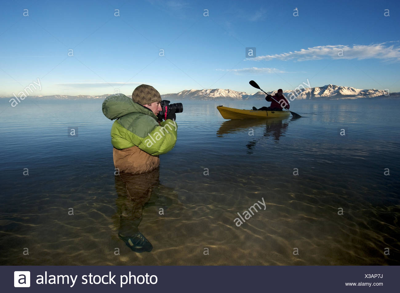 A photographer photographs a kayaker in Lake Tahoe. Stock Photo