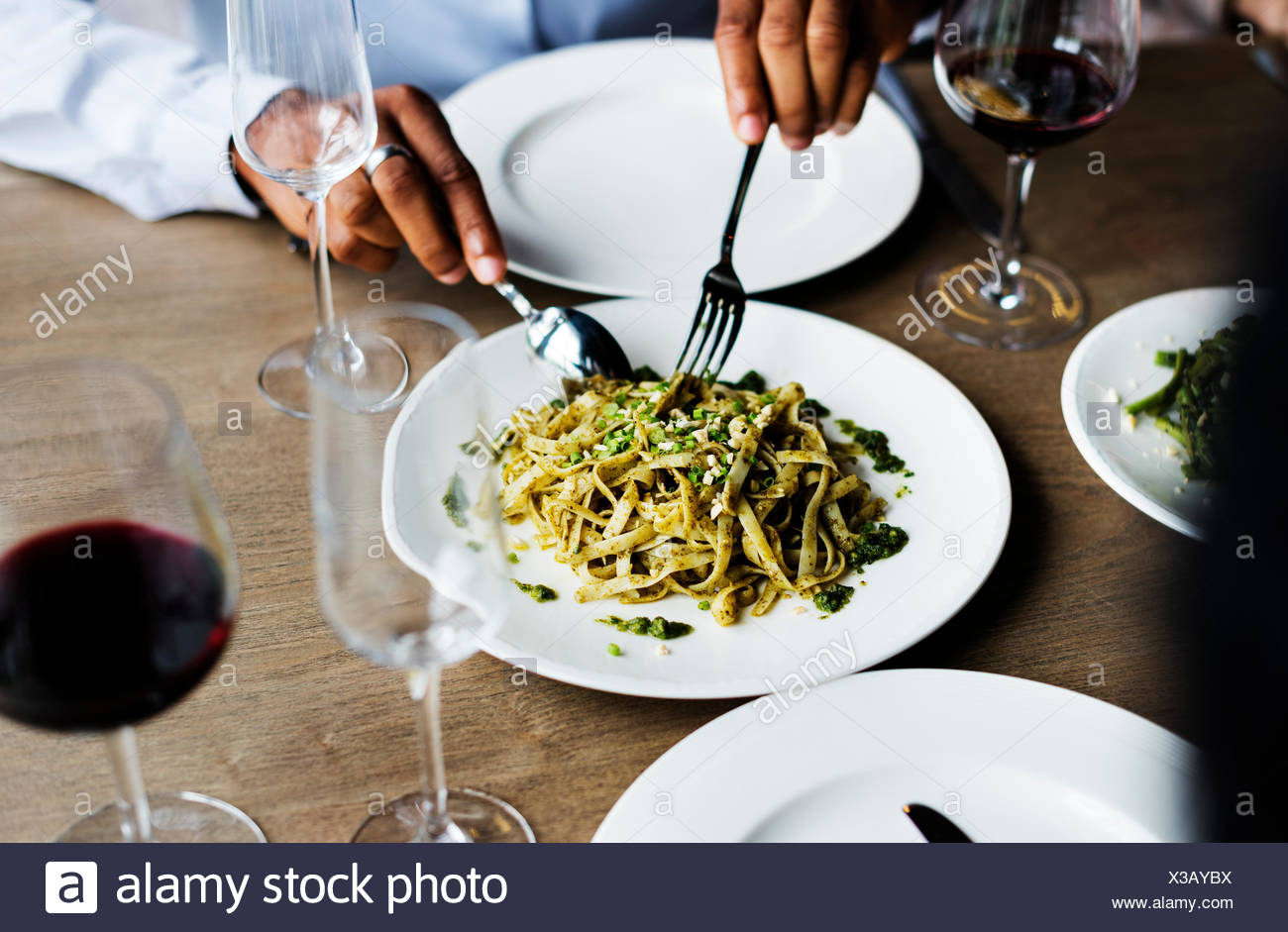 Hands Holding Knife And Fork Getting Food From Dish Stock Photo Alamy