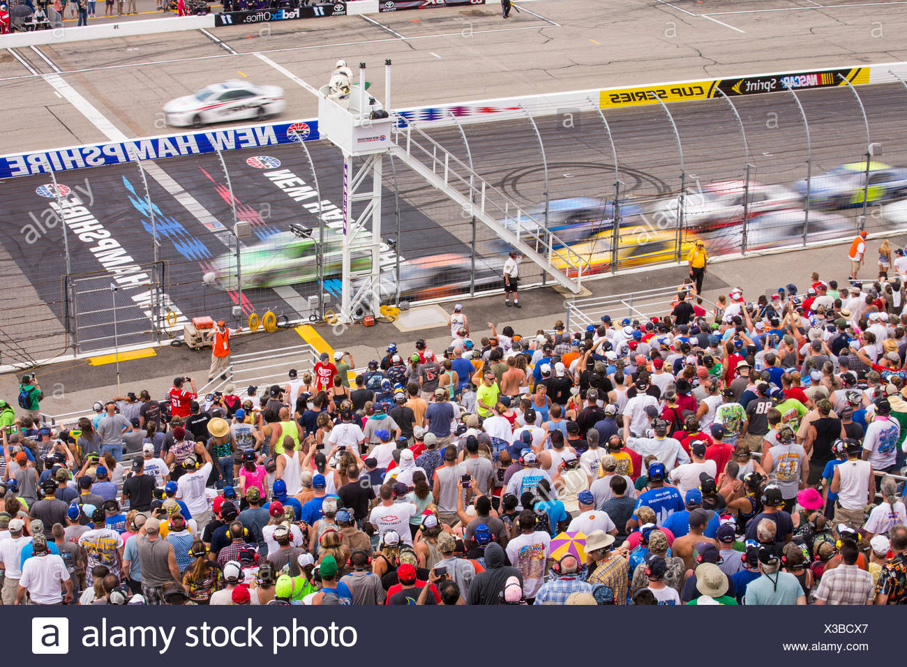 The Crowd Stands As Drivers Accelerate After A Caution Lap At The Nh 301 Nascar Race At New Hampshire Motor Speedway Stock Photo Alamy