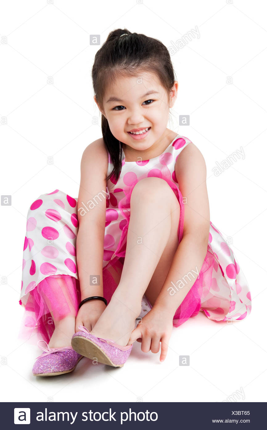 Little girl putting on her shoe Stock 