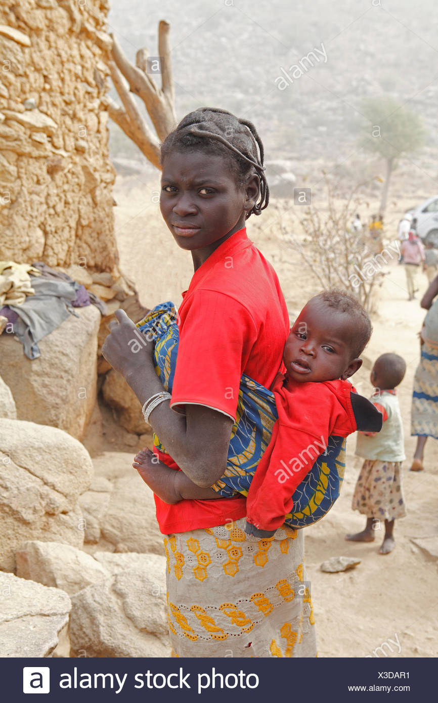 Woman Of The Mafa Ethnic Group Carrying A Baby On Her Back Near Tourou Far North Cameroon Stock Photo Alamy